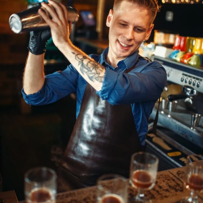 bartender-works-with-shaker-at-the-bar-counter-e1633793140347.jpg
